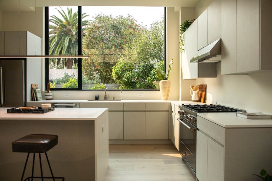 Kitchen with a wide uncovered window above the sink, garden beyond