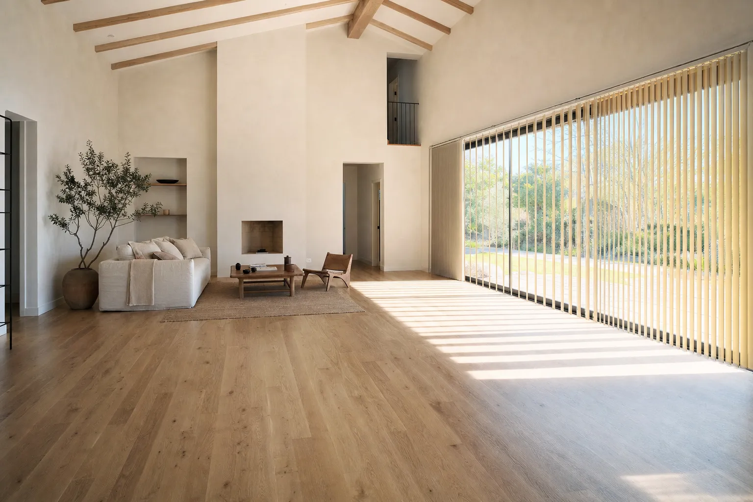 A wide, bright room with a glazed wall of vertical blinds on the right, the vanes angled so daylight falls in tall narrow strips across the whole oak floor